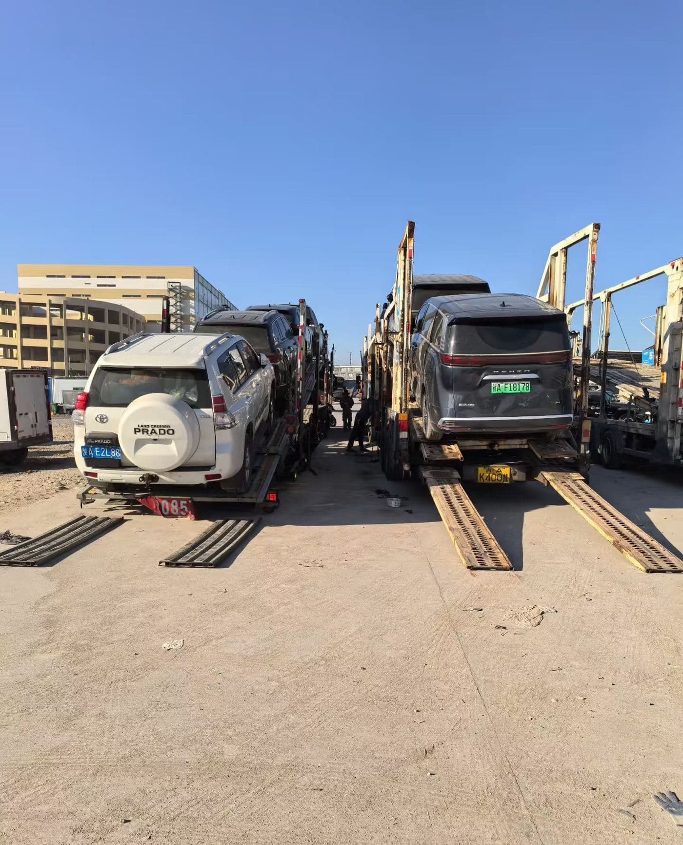 SUVs being driven onto a car-carrier trailer at port